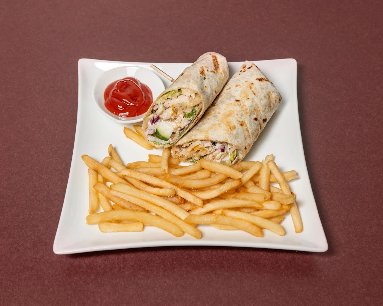 Caesar wrap with chicken, romaine and parmesan, served with fries at The House on Queen&rsquo;s (HQ) in downtown London, Ontario