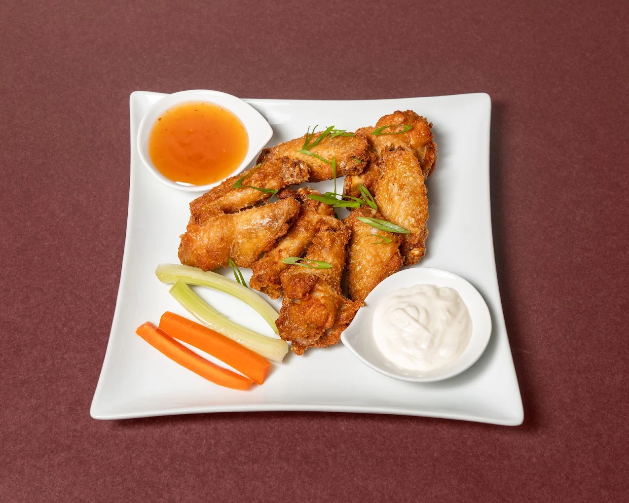 Bird & Bone Wings &mdash; crispy tossed chicken wings in house sauce at The House on Queen&rsquo;s (HQ) in downtown London, Ontario